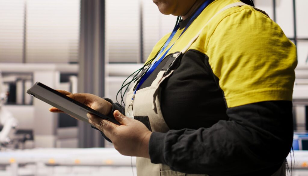 engineer in smart solar manufacturing facility calibrating high tech machinery